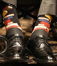 The photo is a close-up of Bush's ankles, adorned with black socks decorated with a stack of blue, read and yellow books. It's a nod to Barbara Bush's main cause during her White House years: literacy.  CREDIT: Paul Morse/Courtesy of Office of George H.W. Bush via AP