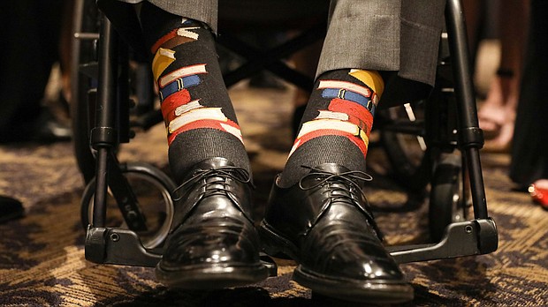 The photo is a close-up of Bush's ankles, adorned with black socks decorated with a stack of blue, read and yellow books. It's a nod to Barbara Bush's main cause during her White House years: literacy.  CREDIT: Paul Morse/Courtesy of Office of George H.W. Bush via AP