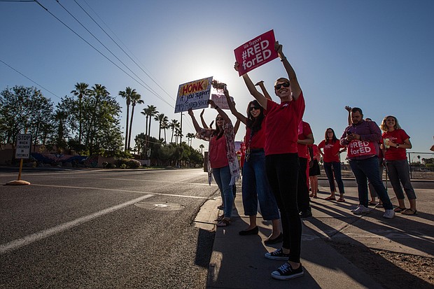 Arizona teachers protest for higher pay and more funding of schools.