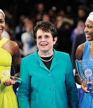 Tennis stars Venus Williams, left, and her sister, Serena, flank former tennis champion Billie Jean King in this March 2009 photo at Madison Square Garden in New York. The Williams sisters are joining the advisory board of the Billie Jean King Leadership Initiative to push for equal pay for women in all jobs.