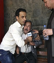 A man cries after his son was killed in an ISIS attack in Kabul, Afghanistan, Monday, April 30./AP