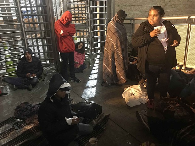 Migrants wait at the US-Mexico border to have their asylum claims processed./Source:	Khushbu Shah/CNN