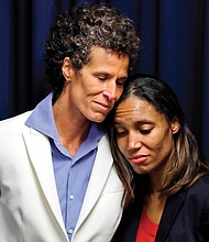 Andrea Constand, 45, left, embraces prosecutor Kristen Feden during a news conference April 26 after a jury found Bill Cosby guilty of drugging and raping her. 