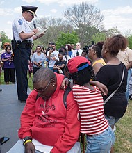 The event was designed to show support for families whose loved ones are missing and provide tools to the community to stay safe. Below left, members of Friends for Farrakhan pick up information about Ms. Jacobs, while Richmond Police Chief, at left, Alfred Durham addresses the crowd. 