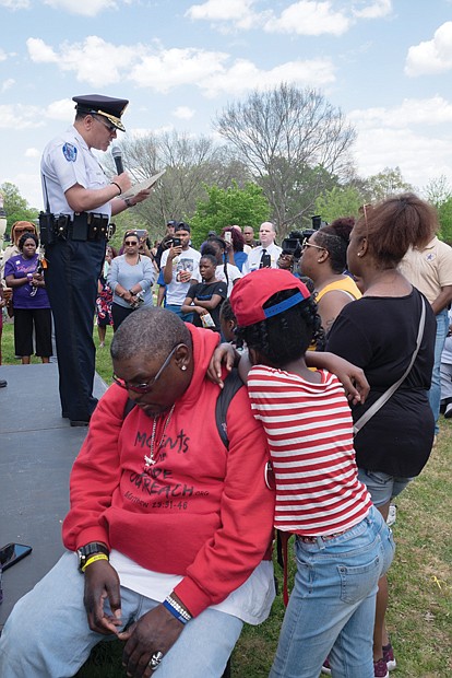 The event was designed to show support for families whose loved ones are missing and provide tools to the community to stay safe. Below left, members of Friends for Farrakhan pick up information about Ms. Jacobs, while Richmond Police Chief, at left, Alfred Durham addresses the crowd.