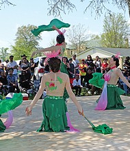 Members of the Red Silk Performing Arts Chinese Dancers, showcase a tribute to the lotus flower. Gospel singer-songwriter and award winner Earnest Pugh also perfomed, along with J-Unity Outreach Choir.