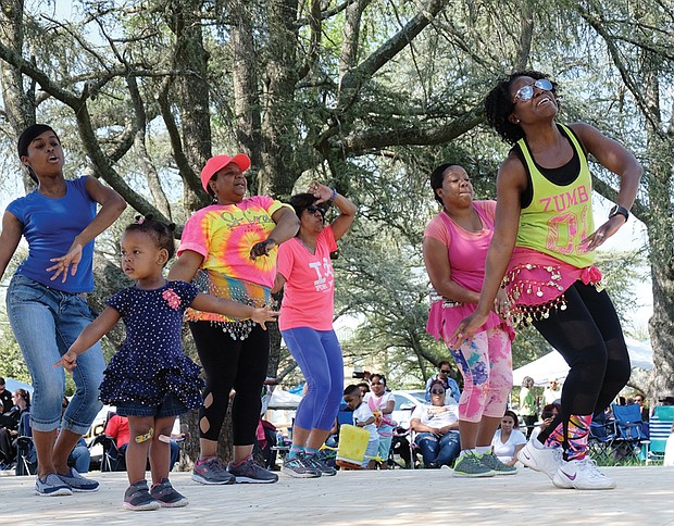 Above right, high steppers from Kickin’ Country show off their moves, while Zumba instructor Tasha King, left, leads a group, including 2-year-old Gabriella Johnson, front left, in a demonstration of the exercise dance.