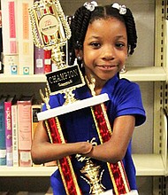 Anaya Ellick holding her award