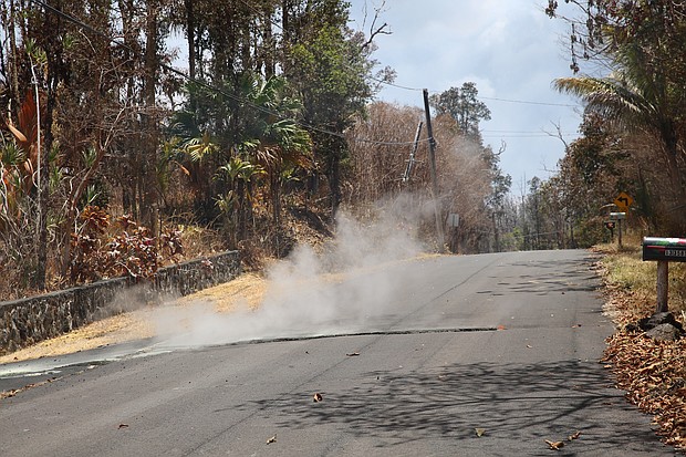 Toxic sulfur dioxide seeps out of the street in Leilani Estates, Hawaii.