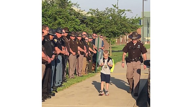 When Dakota Pitt's, 5, returned to school at Sullivan Elemntary School in western Indiana, for the first time after his police officer dad's death, 70 cops stood beside him  Credit: Samantha Phegley/Sulivan Elementary School