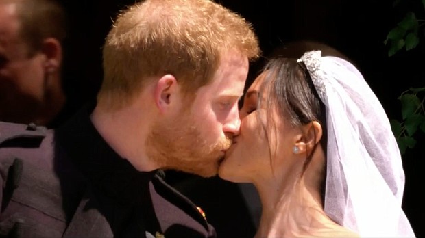 Prince Harry and Meghan share their first kiss as a married couple.