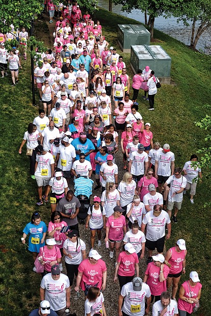 Racing for a cure //
Thousands of people donned sneakers and pink T-shirts for last Saturday’s 21st Annual Susan G. Komen Race For The Cure to raise money for breast cancer. The event featured a competitive run and a recreational run - walk across the James River at the T. Tyler Potterfield Memorial Bridge, along with a cancer survivors’ parade and an awards ceremony. Here, participants walk on Brown’s Island along the canal.