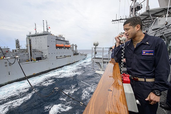 180521-N-HE318-1153 SEA OF JAPAN (May 21, 2018) Ensign Jordan Brooks, from Houston, Texas, communicates with the Lewis and Clark-class dry …