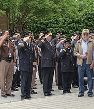 Richmond police, sheriff’s deputies and other law enforcement officers salute family members of the fallen officers. A wreath was placed in front of the monument to the Richmond officers who have been killed in the line of duty since 1889. 