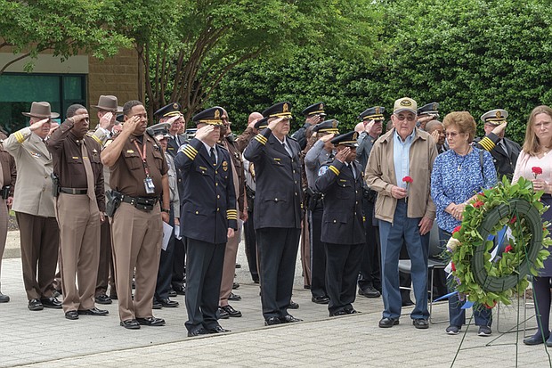 Richmond police, sheriff’s deputies and other law enforcement officers salute family members of the fallen officers. A wreath was placed in front of the monument to the Richmond officers who have been killed in the line of duty since 1889. 