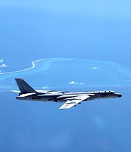 A July 2016 file photo shows a Chinese H-6K bomber patrolling islands and reefs, including Huangyan Island in the South China Sea.