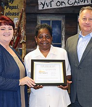 Shari Davis and Toby Edwards, co-directors of the Gulf Coast Shrimp and Jazz Festival, receive the Southeast Tourism Society Top 20 Event award from Sam Wilkinson, chairman of the board of directors of the Lake Charles/Southwest Louisiana Convention & Visitors Bureau.