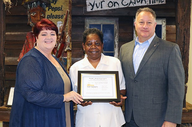Shari Davis and Toby Edwards, co-directors of the Gulf Coast Shrimp and Jazz Festival, receive the Southeast Tourism Society Top 20 Event award from Sam Wilkinson, chairman of the board of directors of the Lake Charles/Southwest Louisiana Convention & Visitors Bureau.