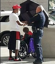 Jordan shielding woman from sun