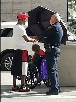 Jordan shielding woman from sun