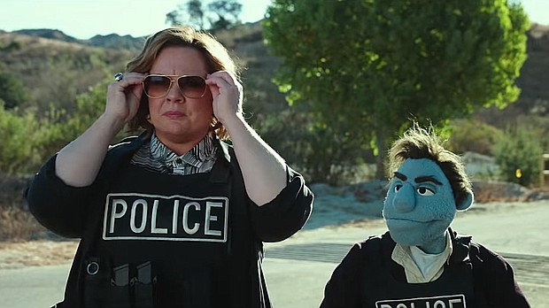 Melissa McCarthy with her puppet co-star in "The Happytime Murders."