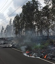Lava creeps across Pohoiki Street in Leilani Estates.