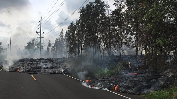 Lava creeps across Pohoiki Street in Leilani Estates.