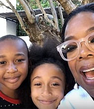 Oprah Winfrey takes a selfie with the CEO and co-CEO of Junior Flips