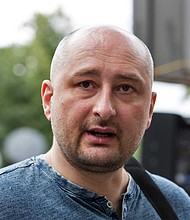 	A Russian journalist and Kremlin critic, reported to have been shot dead in Ukraine, has appeared alive at a news conference.