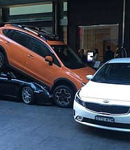 A worker at a hotel valet in Sydney, Australia wedged a Porsche under the SUV parked in front of it and rammed a second parked car against a row of metal bollards.