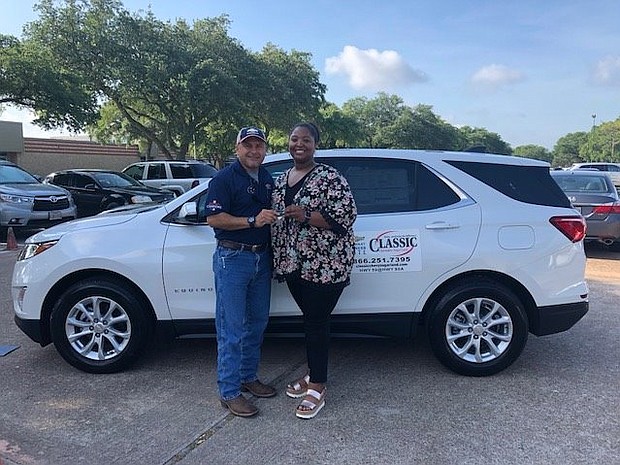 Ray Aguilar, Community Relations Director at Classic Chevrolet of Sugar Land, presents 2017-18 Stafford MSD District Teacher of the Year Ashley Bratcher with a free lease on a 2018 Chevrolet Equinox for the month of June. Aguilar invited Bratcher to return to the Classic dealership in July and August, respectively, to select another free lease for those months