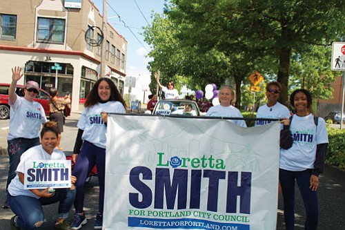 City Council candidate and current Multnomah County Commissioner Loretta Smith waves to onlookers and her supporters carry signs of solidarity at Saturday’s Juneteeth parade.
