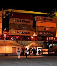 Migrants disembark from the Danish-flagged container ship Alexander Maersk at the Sicilian port of Pozzallo early Tuesday.