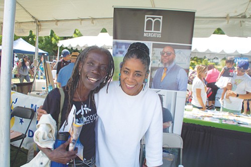 City Council candidate Jo Ann Hardesty greets Chonitia Smith at the Good in the Hood festival grounds.