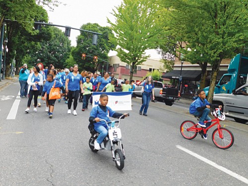 Young people march in the Good in the Hood Parade in conjunction with Legacy Emanuel Hospital.