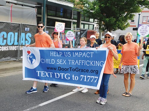 Non-profit Door-To-Grace, an organization helping to cease child sex trafficking, shows out for the parade.