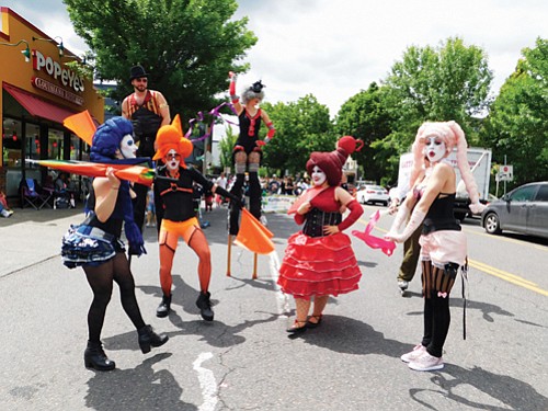 Performers from Rose City Circus awe onlookers with their outfits, athletics, and performance.