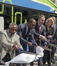 Gov. Ralph S. Northam, fourth from left, helps launch Pulse with federal, state, local and GRTC officials cutting the ribbon on Monday in Downtown. Joining him are, from left, Selena Cuffee-Glenn, Richmond’s chief administrative officer; Frank J. Thornton, chairman of the Henrico County Board of Supervisors; Richmond Mayor Levar M. Stoney; and Shannon Valentine, state secretary of transportation.
