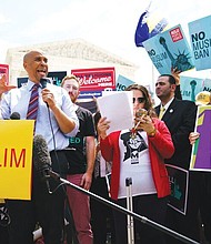 Congressman Cory Booker of New Jersey speaks Tuesday during the “We Will Not Be Banned” protest in front of the U.S. Supreme Court building sponsored by Muslim Advocates.