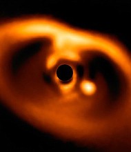 This is the first clear image of a planet caught in the act of formation around the dwarf star PDS 70.  Credit: European Southern Observatory/ESO/A. Muller Et Al.