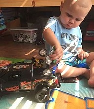 Easton Carraway plays with his toys after just getting home from St. Jude Research Hospital in Memphis.