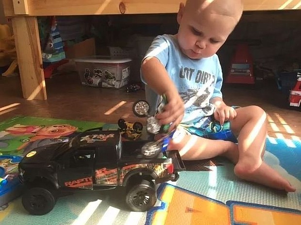 Easton Carraway plays with his toys after just getting home from St. Jude Research Hospital in Memphis.