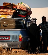 Displaced Syrians wait in a makeshift camp to cross the Jordanian border on July 1, 2018.
