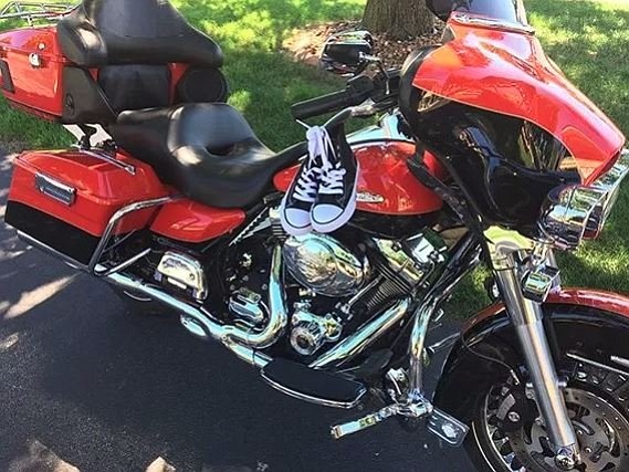 Dennis Wright asked everybody to buy shoes for children rather than flowers for his service.