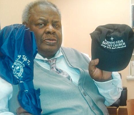 The Rev. Ernest Blue Jr. shows the umbrella and baseball cap he received from Morning Star Baptist Church’s pastor after preaching a guest sermon on July 1. 