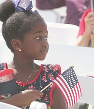 Celebrating a new American-
Arielle Lawson Drackey, 6, waits with family members for her father, Late Lawson Drackey of Fredericksburg, as he takes the oath of citizenship during a July 4 naturalization ceremony at the Virginia Museum of History and Culture. 