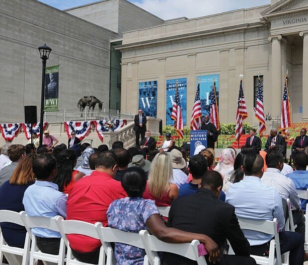 New citizens-
At the podium, Judge Roger L. Gregory, chief judge of the 4th U.S. Circuit Court of Appeals in Richmond, talks to 96 immigrants and their family members during the Fourth of July naturalization ceremony where they officially became U.S. citizens. The ceremony was held outside the Virginia Museum of History and Culture on the Boulevard. 