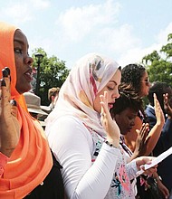 New citizens-
Judge Roger L. Gregory, chief judge of the 4th U.S. Circuit Court of Appeals in Richmond, talks to 96 immigrants and their family members during the Fourth of July naturalization ceremony where they officially became U.S. citizens. The ceremony was held outside the Virginia Museum of History and Culture on the Boulevard. Above left, Henrico County resident Hanan Mohamed, 26, a native of Sudan, takes the citizenship oath with people from more than 40 countries. 