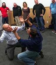 Nimeet Shah, right, practices the "mirror game" with his classmates.