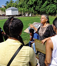 Ana Edwards, chair of the Sacred Ground Historical Reclamation Project, leads a tour in July 2016 of the African Burial Ground and Lumpkin’s Jail site in Shockoe Bottom. Her audience is composed of young people taking part in a summer leadership program sponsored by the Maggie Walker National Historic Site.